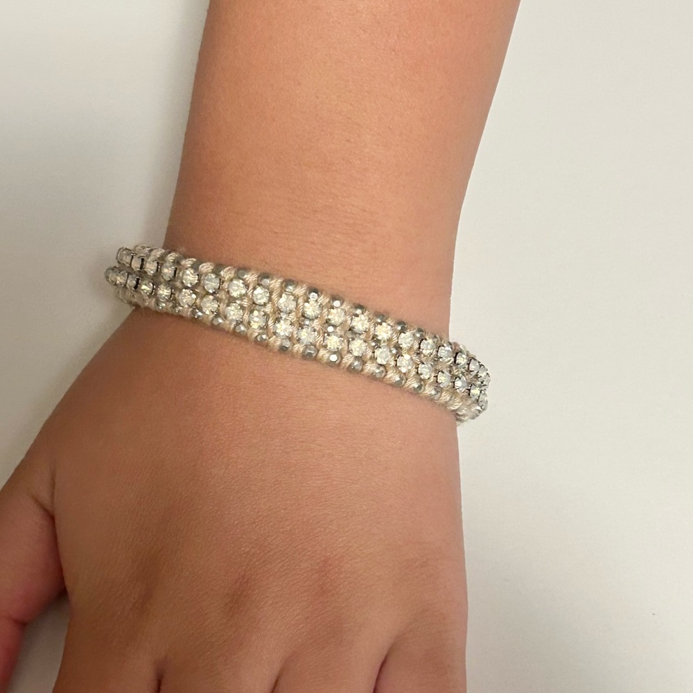 Rhinestone and pink yarn silver tone bracelet